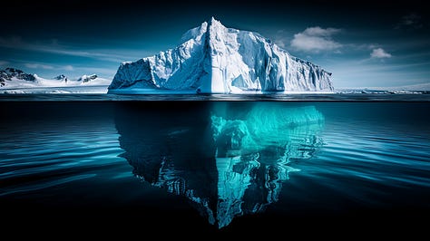 Split-level shot of iceberg, revealing massive underwater structure beneath surface