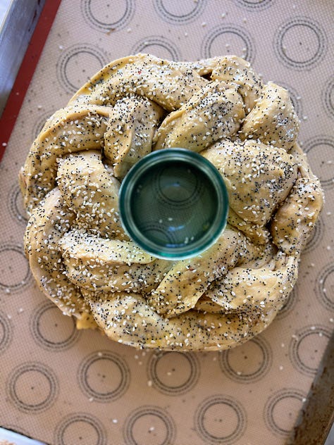 Pictures show process of stuffing challah dough with apples and weaving it into a crown around a jar that is then filled with honney.