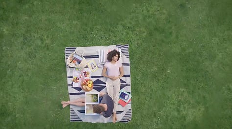 A grid of six images showing scenes from the "Powers of Ten" film. Top row, left to right: A close-up of two people lying on a picnic blanket with various items around them; a more zoomed-out view showing them as a small spot on a large expanse of grass; and a view of Earth from space. Bottom row, left to right: a sequence of images showing views at different scales, starting from Earth and zooming in closer until individual objects and patterns appear; a close-up of a man lying on the picnic blanket; and the title screen reading "Powers of Ten."