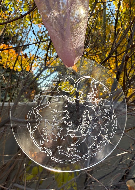 Image 1: Acrylic "Inspired by Nature" ornament engraved Bear with cub. Image 2: Acrylic Embryo engraved ornament. Image 3: "Inspired by Nature" Silver Nugget with Mountains Pendent with silver necklace. Image 4: Acrylic engraved "Our Cubs" ornament placed on a Christmas tree. Image 5: Silver Nugget Pendent "Sand Dollar" with silver necklace. Image 6: Silver Nugget Pendent "Daisy" with silver necklace.