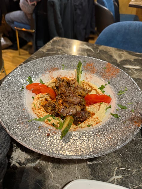 Three images from left to right, a pita bread on a wooden plate; hummus with lamb, bell peppers and cucumber; the turnip drink with a red liquid