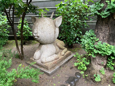 Takashi Murakami sculpture at Kyocera Museum, witch miffy in a blue background, free gaza embroidered sign at sanjo bridge in kyoto, ice cream with a link chocolate bear on top, emoty glass of matcha with some bits of green and ice still there, sculpture of a deer surrounded by greenery