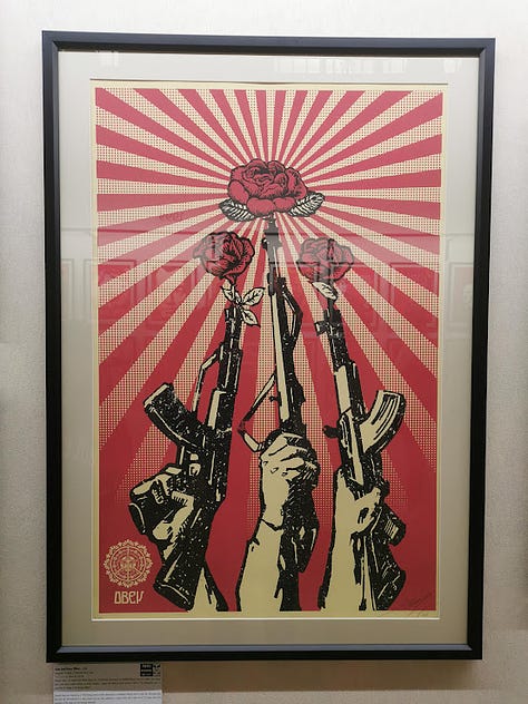 Photos of Shepard Fairey silkscreen prints in a large exhibition hall