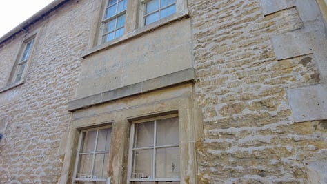 Two old cottages, numbers 75 and 77 High Street, Corsham, Wiltshire. Number 75 has the remains of the sign for the Temperance Hotel above a ground floor window. Images: Roland's Travels
