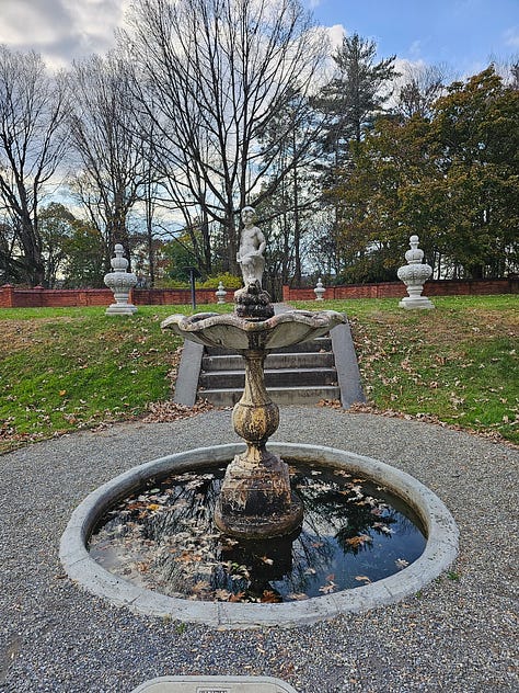 The garden with brick gazebo and fountain that is not running.