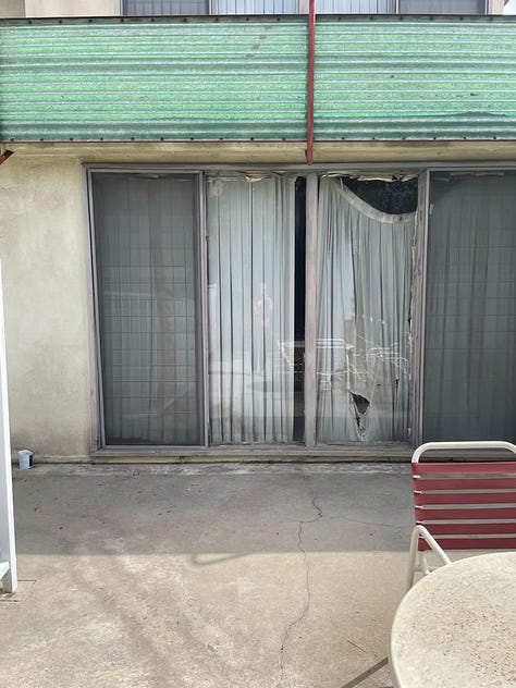 2040 Rodney Avenue, a midcentury modern apartment complex that has been empty for years and is suffering from deferred maintenance (mold, stucco damage, peeling paint, a long-empty pool, cracked concrete, rust stains, etc.).