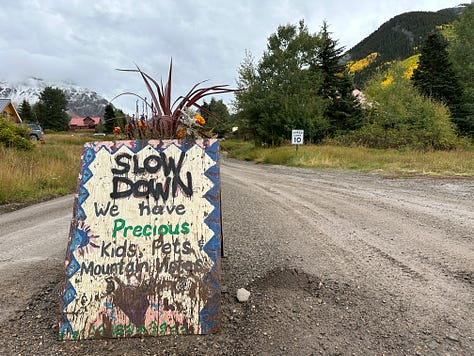 various handmade signs telling you to slow down