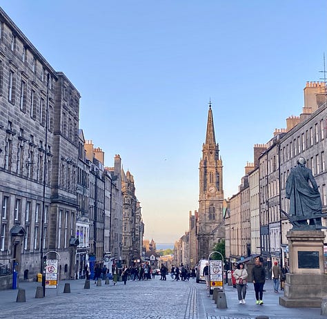 The Royal Mile; the front of Scotland's Parliament building; a statue of Adam Smith in front of St. Giles Cathedral. Photos: Miranda Miller, 2025.