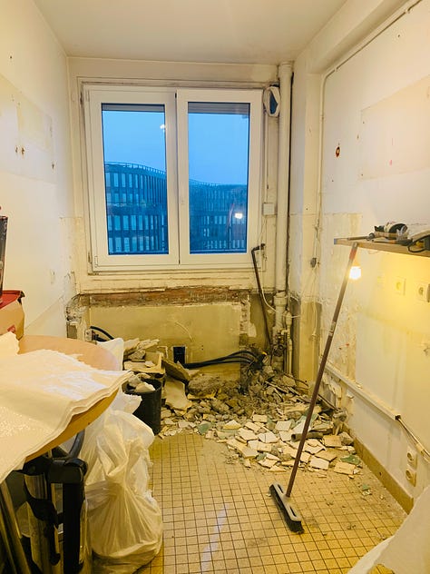 A man does DIY kitchen renovation in a Paris apartment