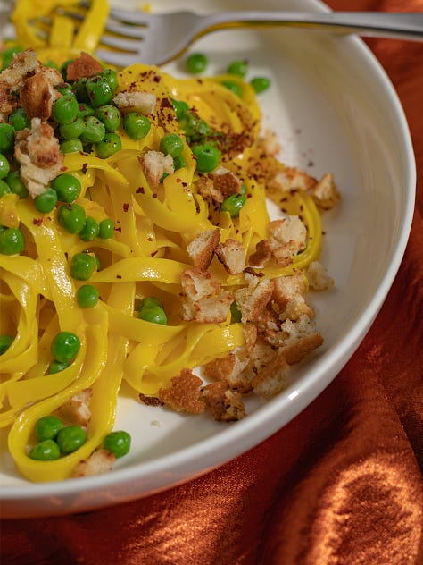 fairy lights under a cloche, saffron tagliatelle with peas, glass that's been tinted with alcohol ink