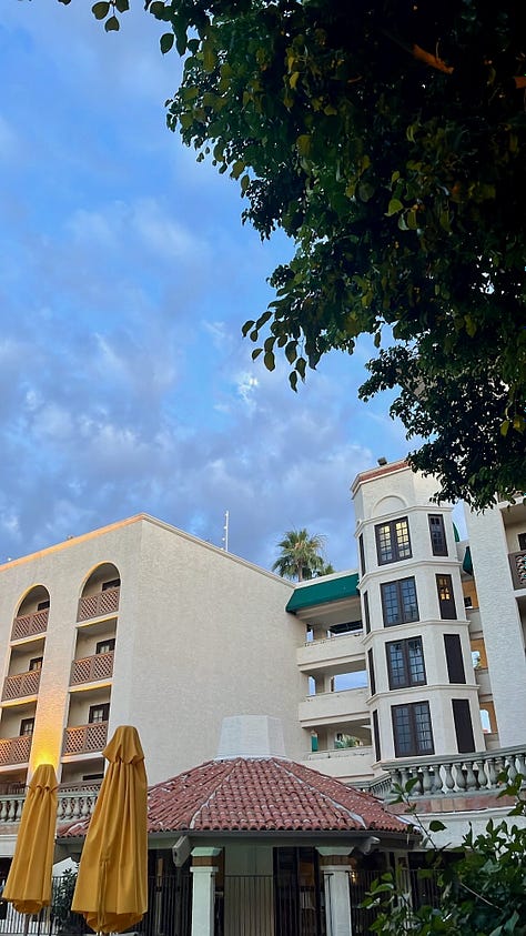 Sky and white stucco buildings in the evening and night