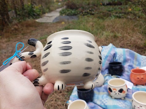 Kitty shaped mugs from different angles.