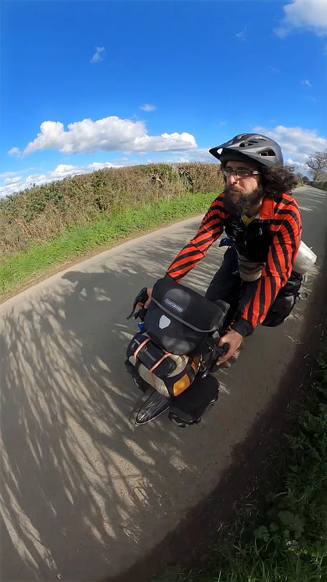 Ghandi cycling his bike through the Shropshire countryside during a beautiful sunny spring day.