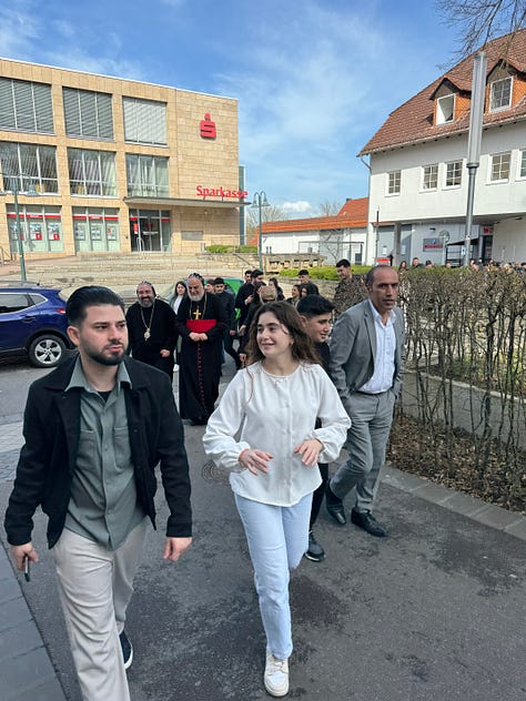 A number of people taking a walk and posing for photos