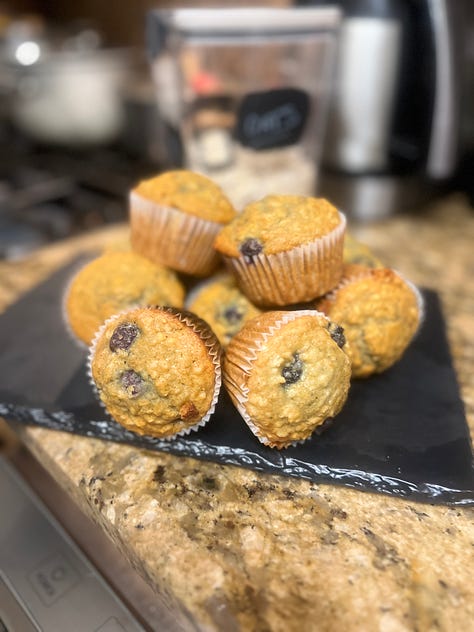 L to R: Plate of blueberry muffins, a 12 cup tray of muffins in the oven, a open blueberry muffin