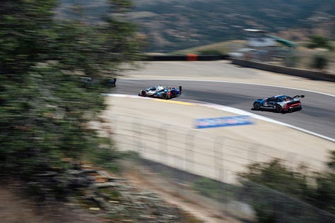 The No. 24 and No. 25 BMW M Team RLL racecars speed across Laguna Seca during the IMSA Monterey round in May 2025. Photos by Walter Fulbright.