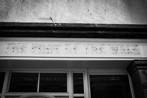 Black and white photographs of The foot of the Walk after it closed. The sign has been removed.