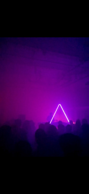blue or purple lights in foggy dance floors with silhouettes of people in foregrounds