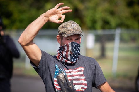Photos of members of the Proud Boys making the "OK" sign