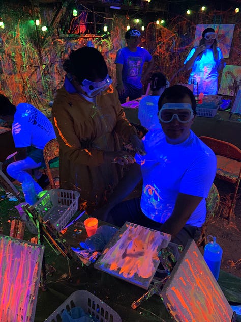 Graduate students paint their canvases and themselves with psychedelic neon paint