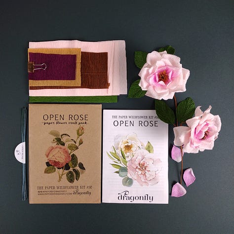 Three images of the new open Rose CraftKits showing the contents of the kit, paper, wire and instructions, plus the finished roses, very pale pink with a darker pink centre, a dark brown stem and deep green leaves.
