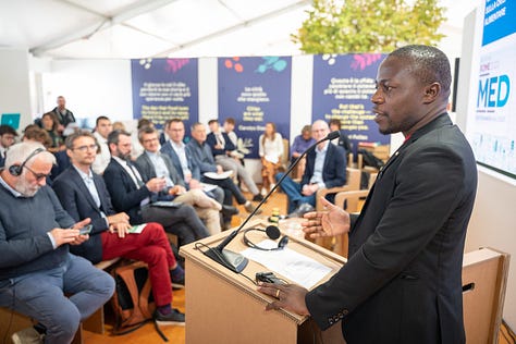 Scenes from previous Terra Madre presentations with people listening intently to speakers, including an image of Carlo Petrini, 