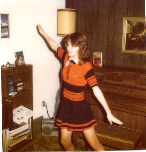 Hideous proof of the author's 7th grade fiasco: glasses, braces & headgear, some train wreck of a Halloween costume with home made Bermuda shorts, a feathered cape, and a bird beak. At least there was redemption of the cheer-nerd in orange, black and four eyes.