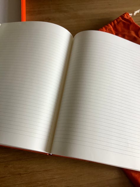 Orange notebook with velvet bag and box ready for writing poems into