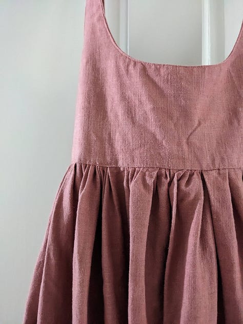 Three partial images of a pinkish pinafore dress.