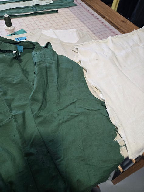 A green and tan shirt partially dissassembled.