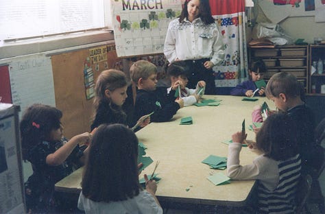 Children making paper shamrocks for St. Pat's Day