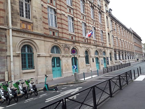 A street closed off to vehicles with railings.