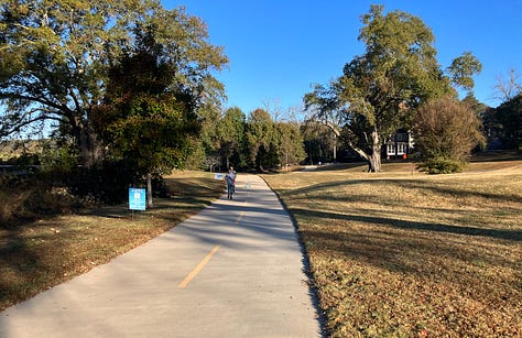 The trail is of consistent width, terrain and layout; grey with a yellow line down the middle