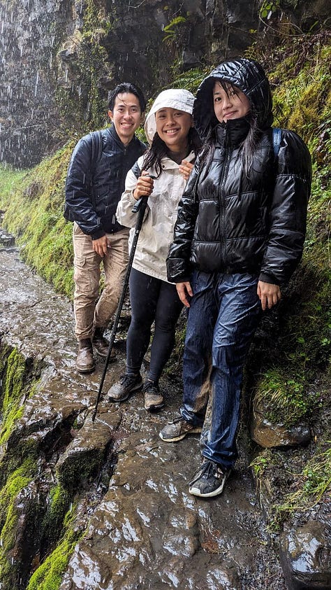 people smiling at the waterfalls of the brecon beacons