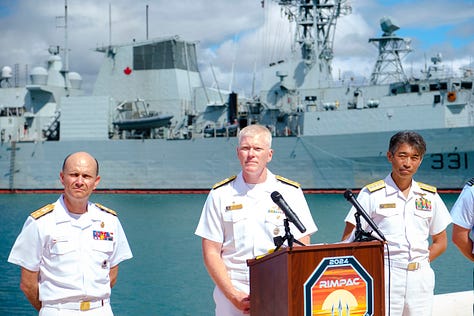 In-port naval open house images including a press conference. One image of the USS Carl Vinson steaming out of Pearl Harbor as a passanger jet takes of at HNL.