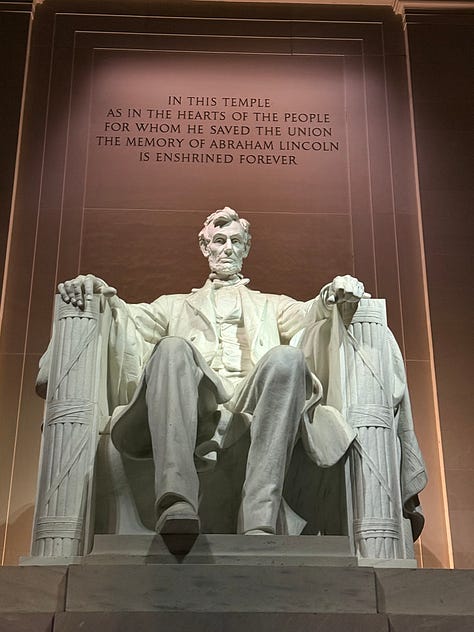 The Jefferson Memorial illuminated at night, a prominent U.S. landmark with its classical dome and columns. A close-up of the Lincoln Memorial statue, showing Abraham Lincoln seated, with part of the inscription visible above him. A nighttime view of the Lincoln Memorial, with its reflection visible on the water of the reflecting pool in front of it.