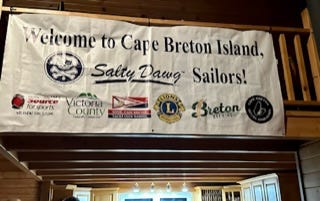 Saturday am cafe music in St. Peter’s, fireworks farewell, Kitchen Party, Flo Sampson and nephew, welcome banner, Barra Strait Bridge in Bras d’Or Lake, oatcakes from High Wheeler Cafe in Baddeck(recommend!), grocery portage. 