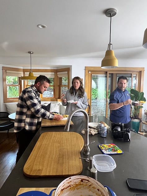 Stephanie in her kitchen with other people, doing a photo shoot.