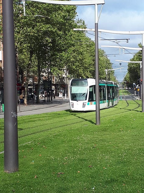 Images of LRT tracks amid grass, with an LRT train approaching.