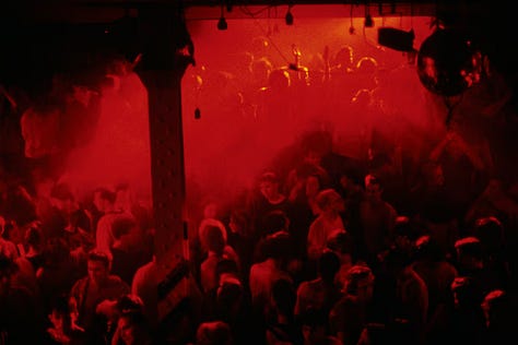 A nightclub and people dancing and partying