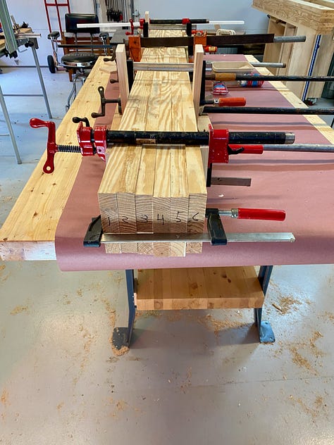 Gluing up the top: Ordering boards, rolling on glue, clamping, a gap opens, trying to close the gap, creating space for a planing stop, more gluing up, popping out the placeholder. 