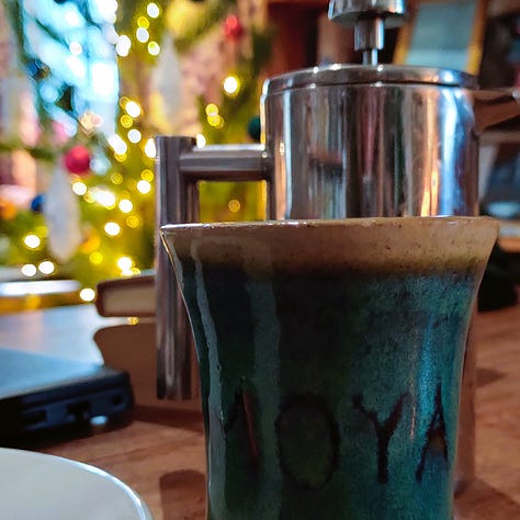 Three pictures: the first, a desk in front of a window. There is a mug and writing implements on it. The middle picture has a coffee cup and coffee. The final picture shows a print of Alison Watt's Sabine on a brick wall