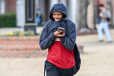 Students walk across the Troy campus heading to class