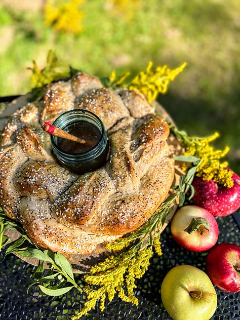 Pictures show process of stuffing challah dough with apples and weaving it into a crown around a jar that is then filled with honney.