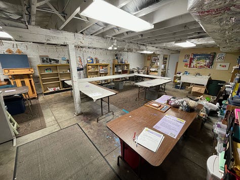 Swap tubs in a retail store, empty tables arranged in a basement, the same tables beginning to fill with materials, and a wide range of donated supplies on those tables from paint to frames.