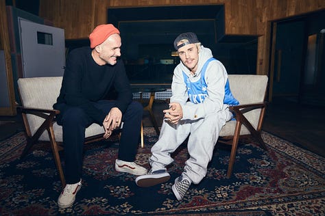 Zane Lowe photographed with Justin Bieber, Harry Styles, and Kendrick Lamar.