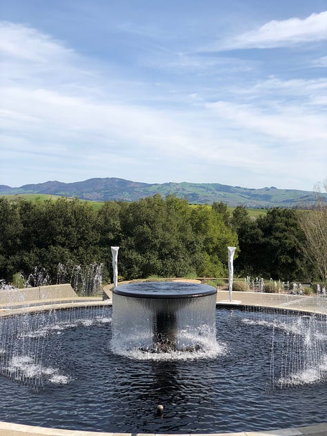 Beautiful Sonoma Winery including a fountain with blue water overlooking the vineyard