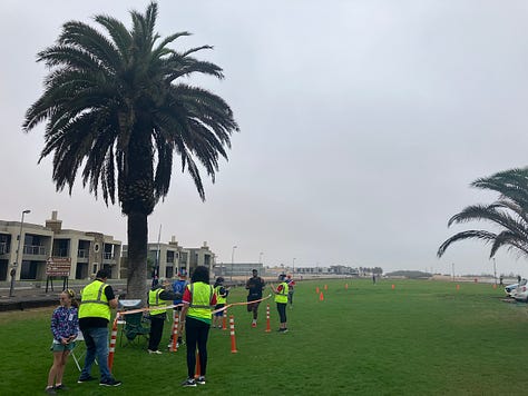 The finish line and parkrun flag on the grassy area by the lagoon