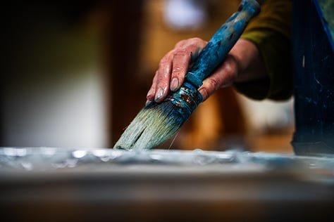 Picures showing the process of laying metal leaf onto painting panels