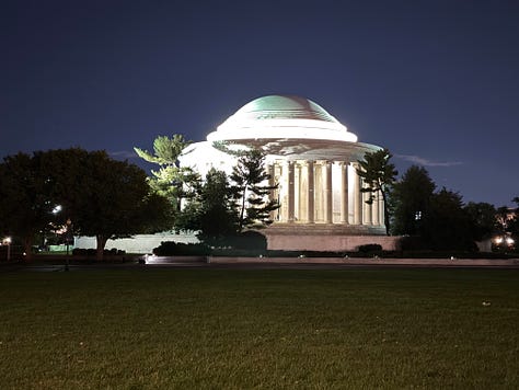 The Jefferson Memorial illuminated at night, a prominent U.S. landmark with its classical dome and columns. A close-up of the Lincoln Memorial statue, showing Abraham Lincoln seated, with part of the inscription visible above him. A nighttime view of the Lincoln Memorial, with its reflection visible on the water of the reflecting pool in front of it.